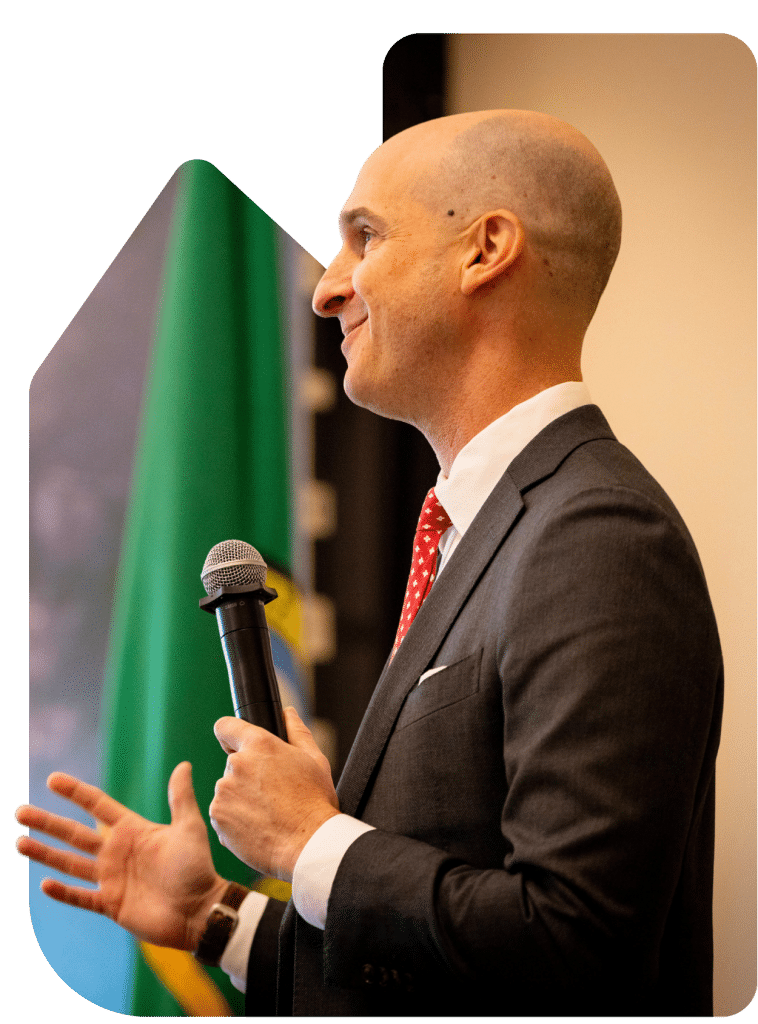 Keynote Speaker Adie Tomer presenting with microphone at Regional Transportation Summit